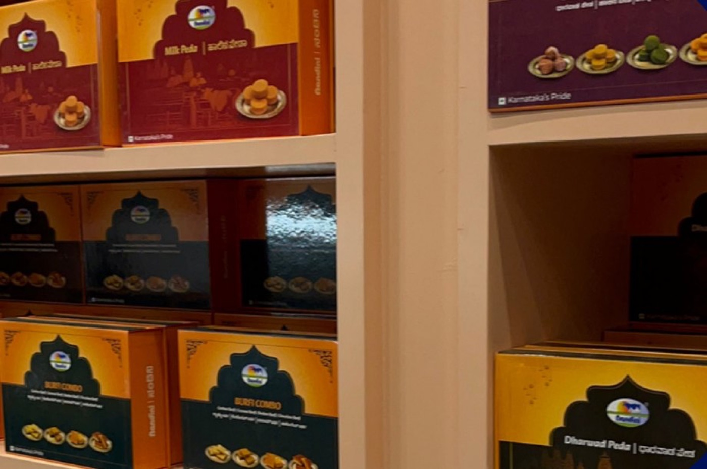 Milk Peda and Dharwad Peda boxes on the airport shelf